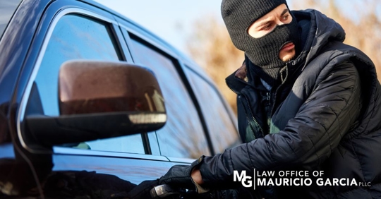 man in a mask trying to steal a car